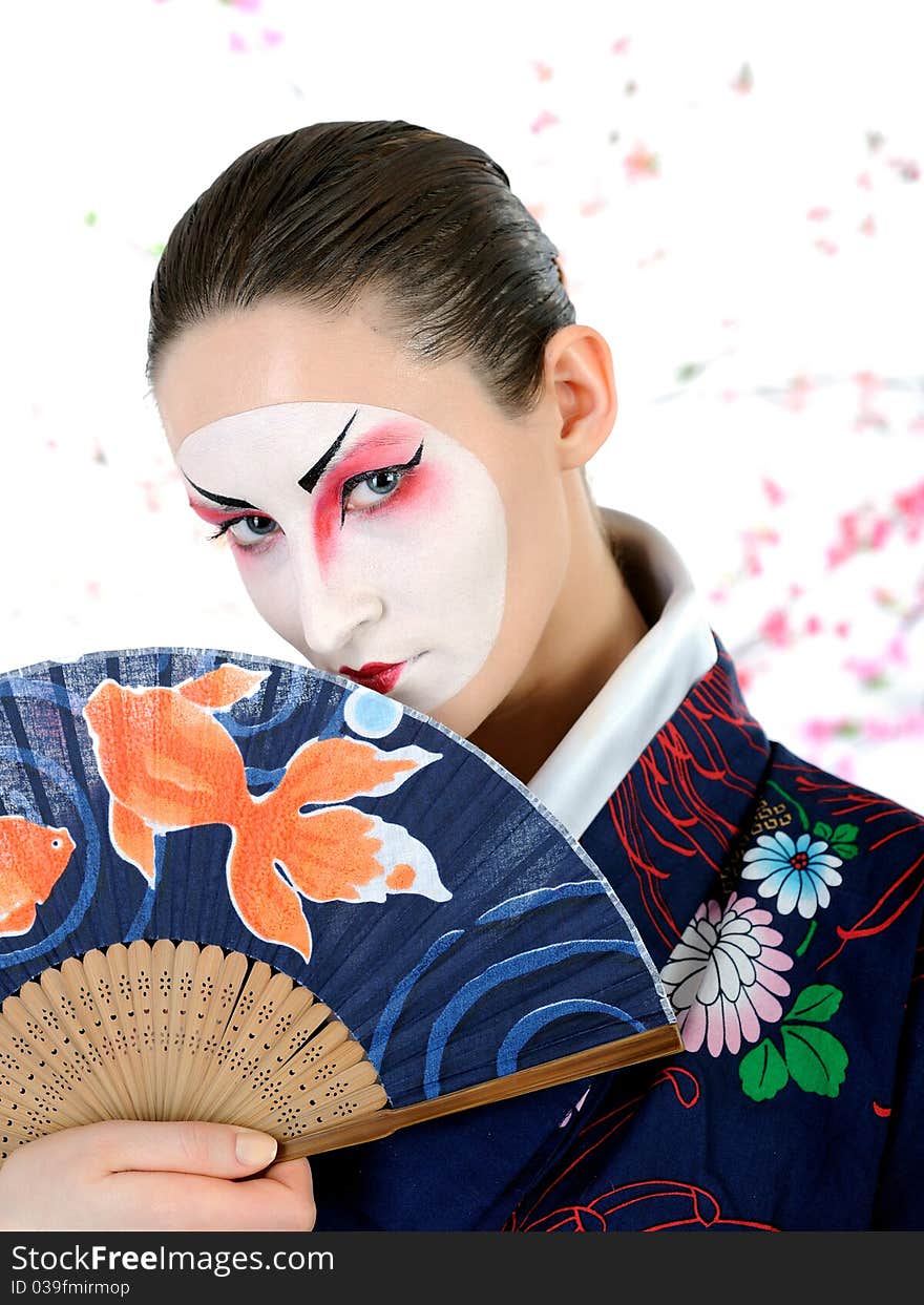 Japan geisha woman with creative make-up with fan