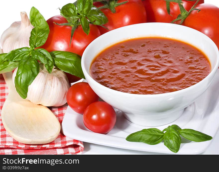 Tomato soup with basil leaves and vegetables