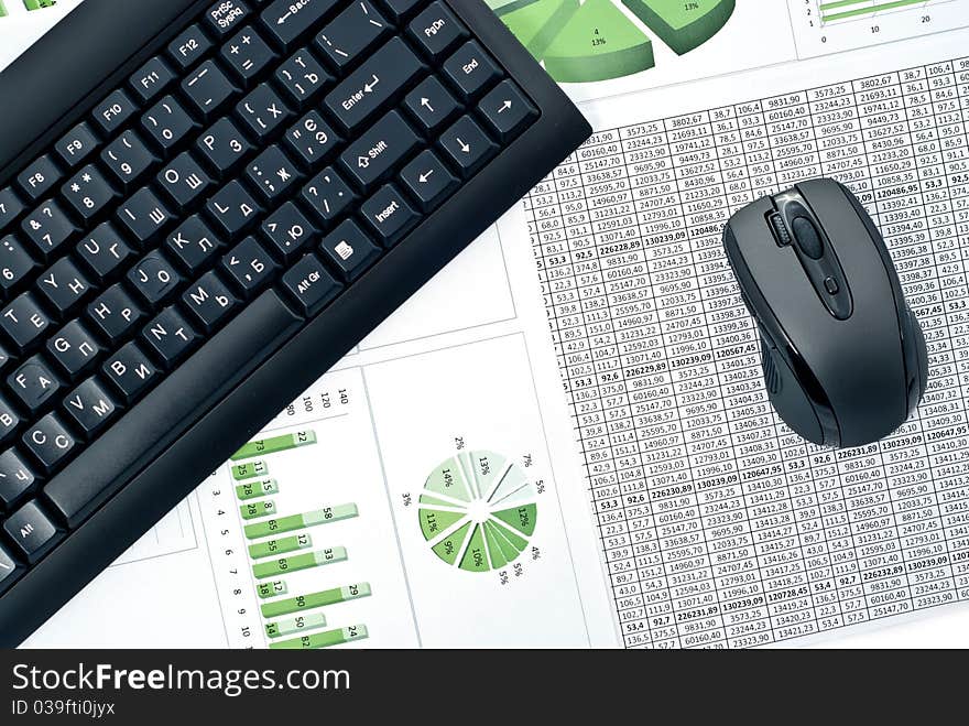 Black keyboard and mouse on a stock chart. Black keyboard and mouse on a stock chart.