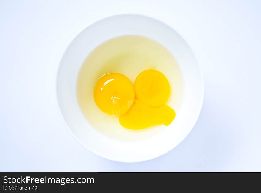 Raw egg in the cup for cooking. Raw egg in the cup for cooking.