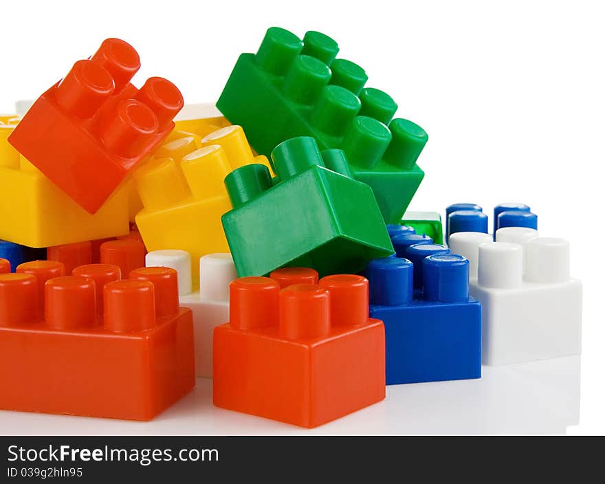 Colorful plastic toys bricks isolated on white background