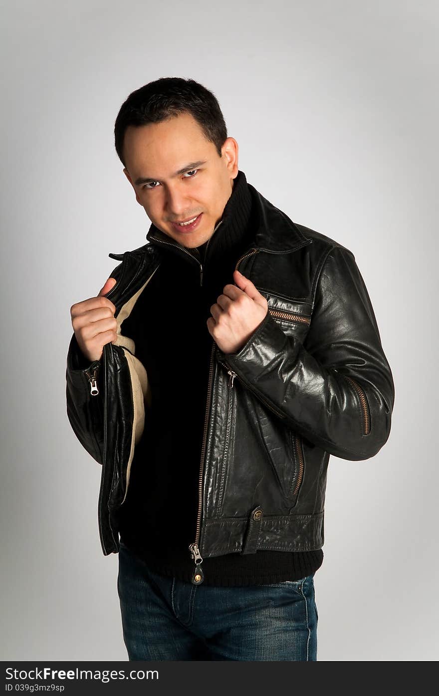 Tough attractive man with look in black leather jacket on white background isolated. Tough attractive man with look in black leather jacket on white background isolated