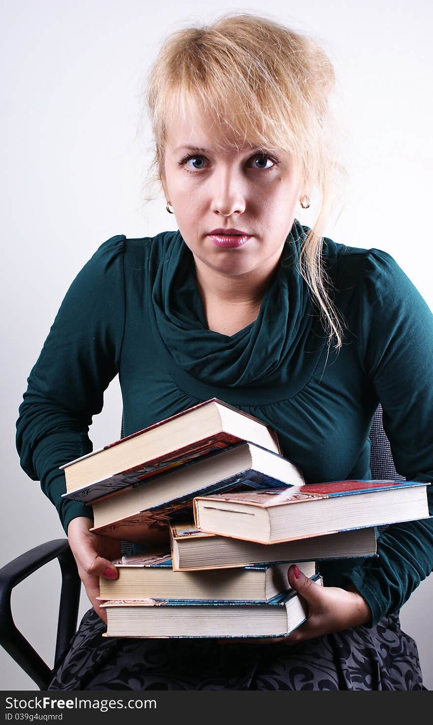 girl holds the pile of books. girl holds the pile of books