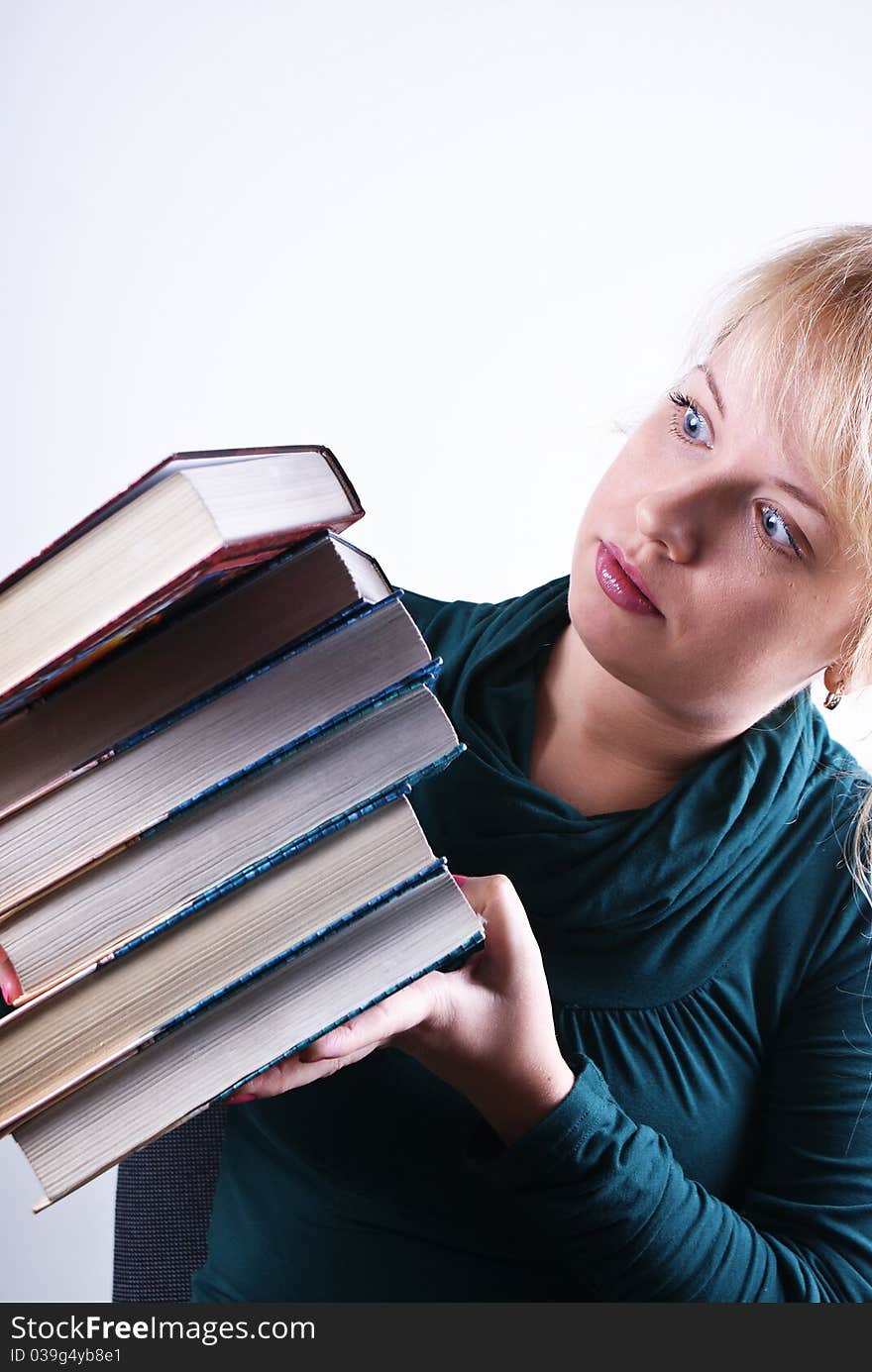 girl holds the pile of books on white