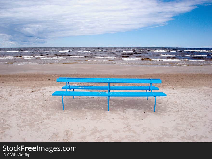 Blue bench on the beach