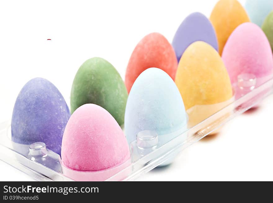 Colorful easter eggs in a tray on a white background