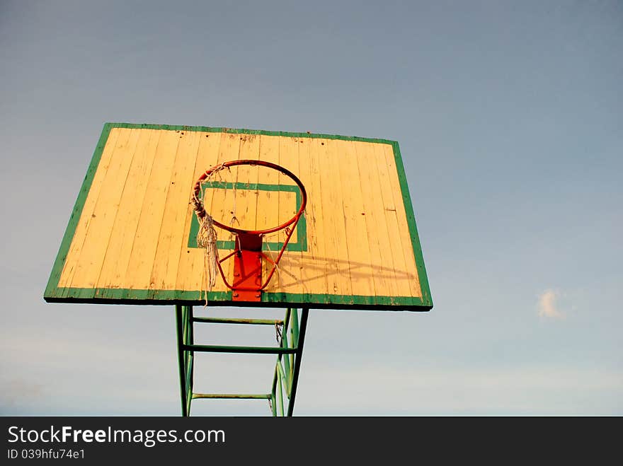 Basketball board with an old tattered basketball net on the hoop