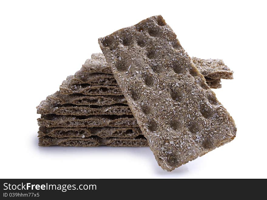 Stack of brown crisp bread with one in the front