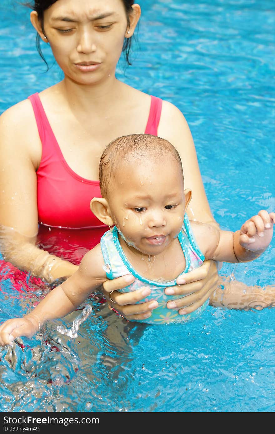 Asian ethnic mother teach baby girl to swim. Asian ethnic mother teach baby girl to swim