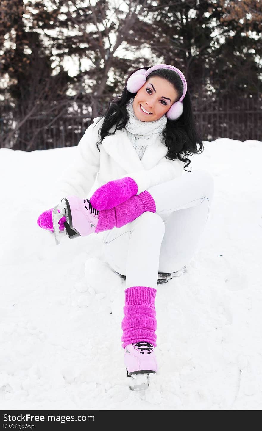 Happy beautiful girl wearing warm winter clothes ice skating. Happy beautiful girl wearing warm winter clothes ice skating