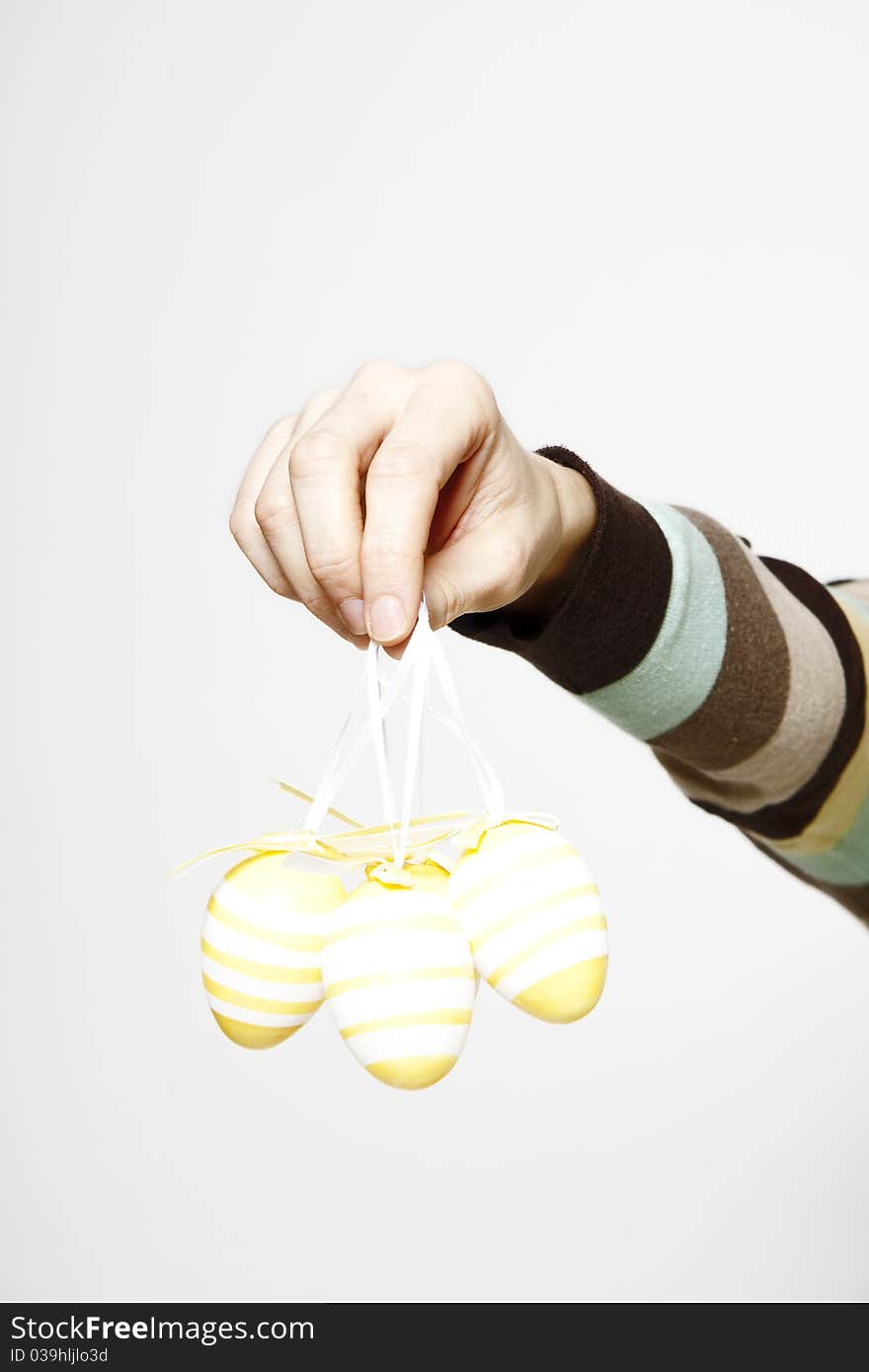 Woman hand with decorated easter eggs