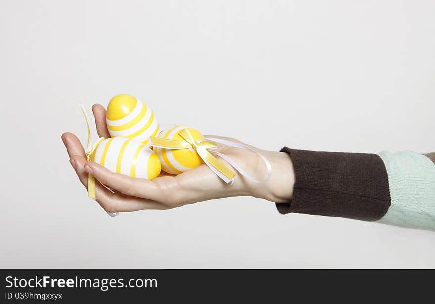 Woman hand with decorated easter eggs