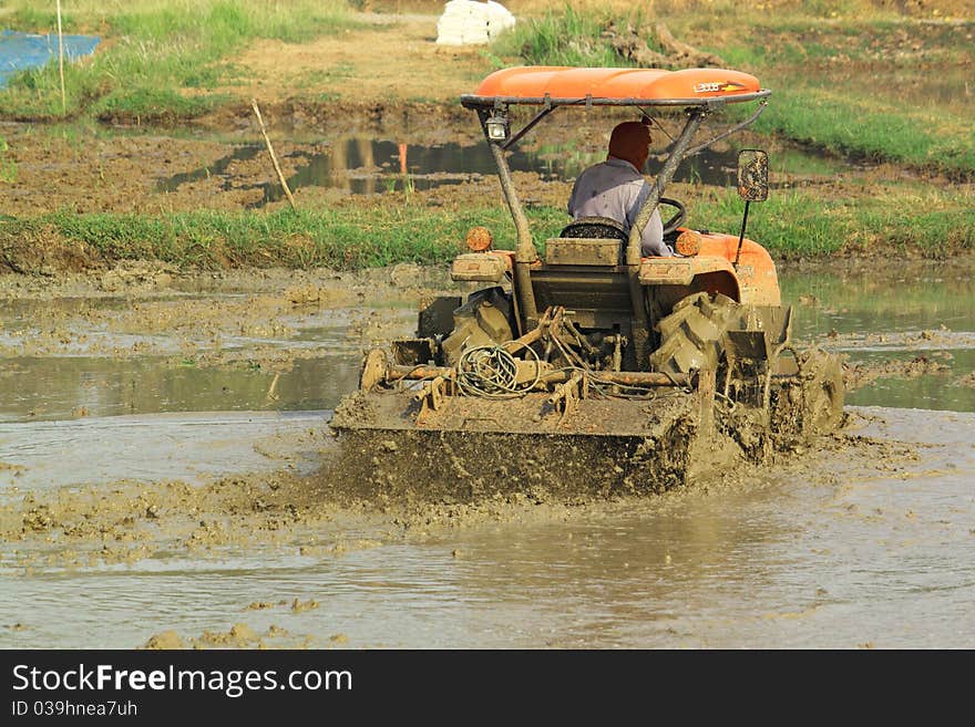 There is a famer working in the farm