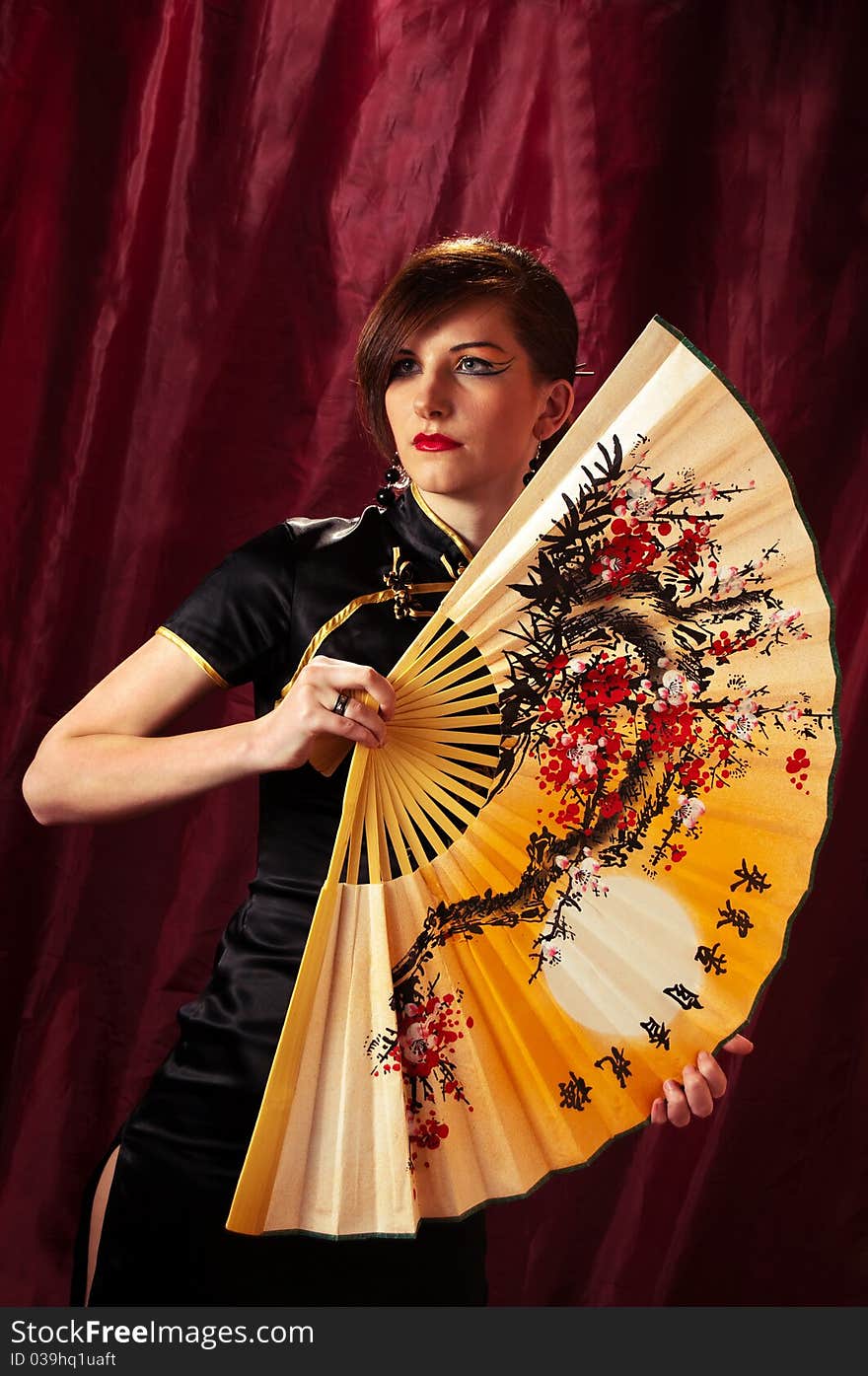 Samurai Girl in kimono with fan on red background. Samurai Girl in kimono with fan on red background