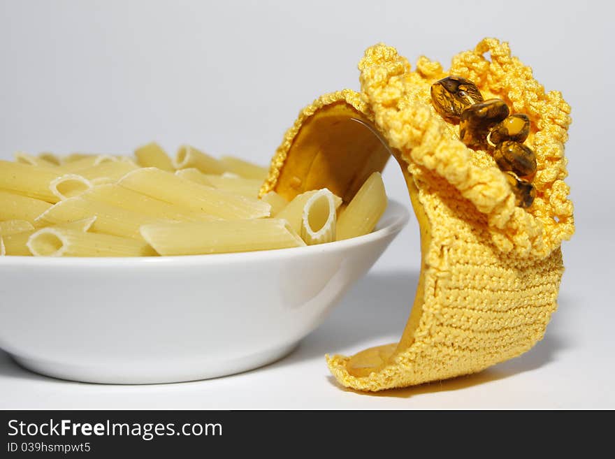 A plate of pasta with a unique hand made bracelet. A plate of pasta with a unique hand made bracelet