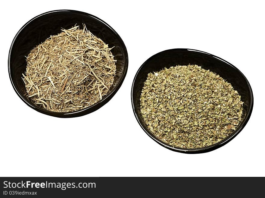 Rosemary and marjoram spices in bowls.