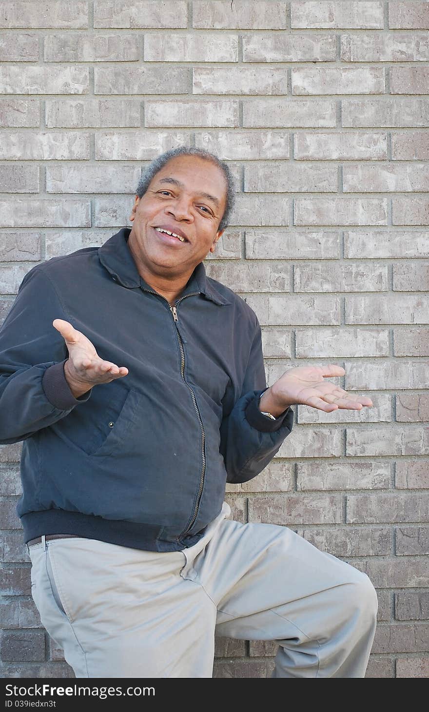 Expressions of an african american male standing against a wall outdoors. Expressions of an african american male standing against a wall outdoors.