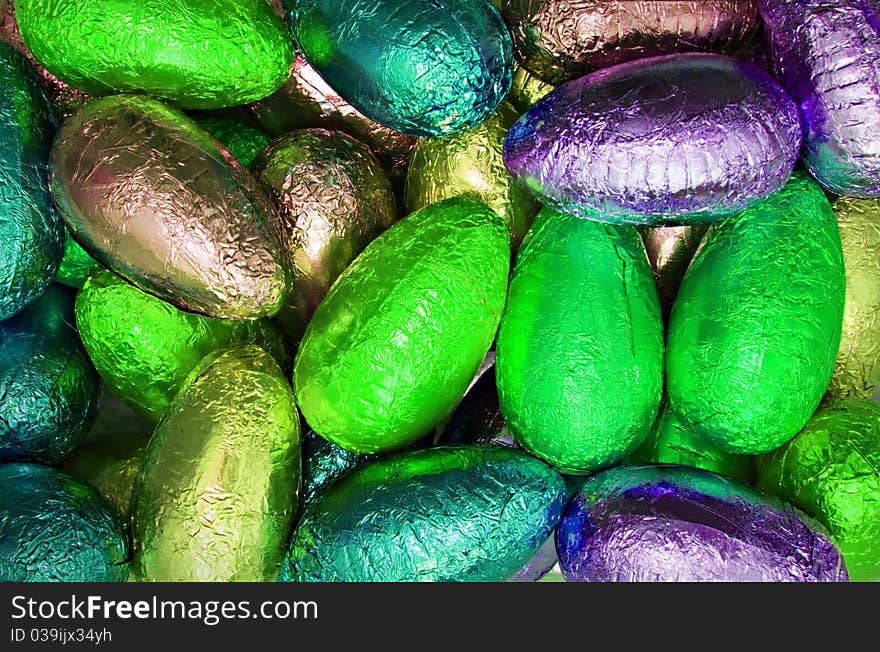 Variety chocolate easter eggs wrapped in colorful neon shiny foil. Variety chocolate easter eggs wrapped in colorful neon shiny foil