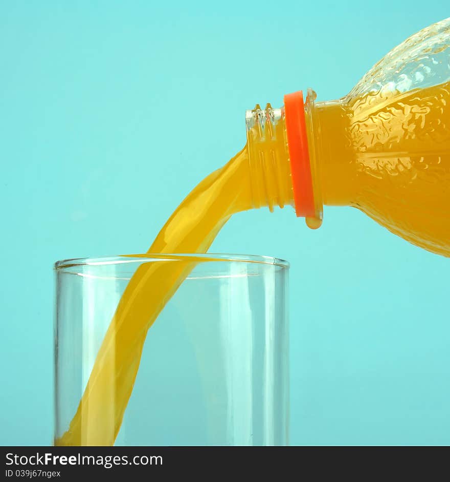 Glass with orange juice on the blue