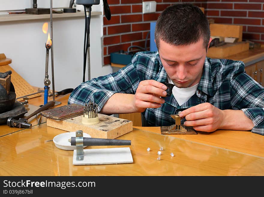 Goldsmith in workshop. Making of jewelery. Handmade.