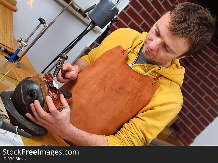 Goldsmith in workshop. Making of jewelery. Handmade.