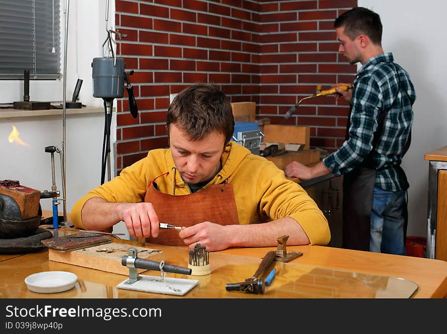 Goldsmith in workshop. Making of jewelery. Handmade.