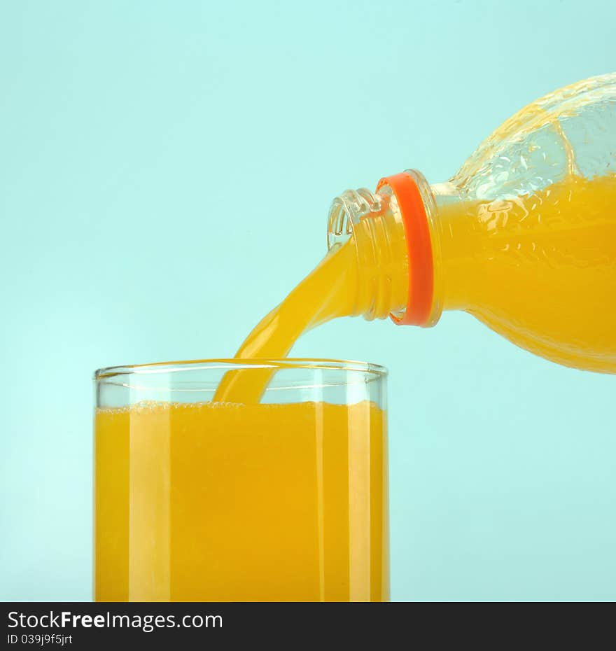 Glass with orange juice on the blue