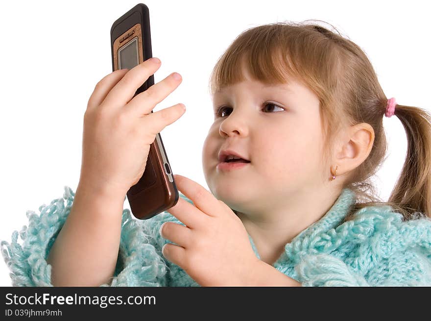 The little girl speaks by phone on white