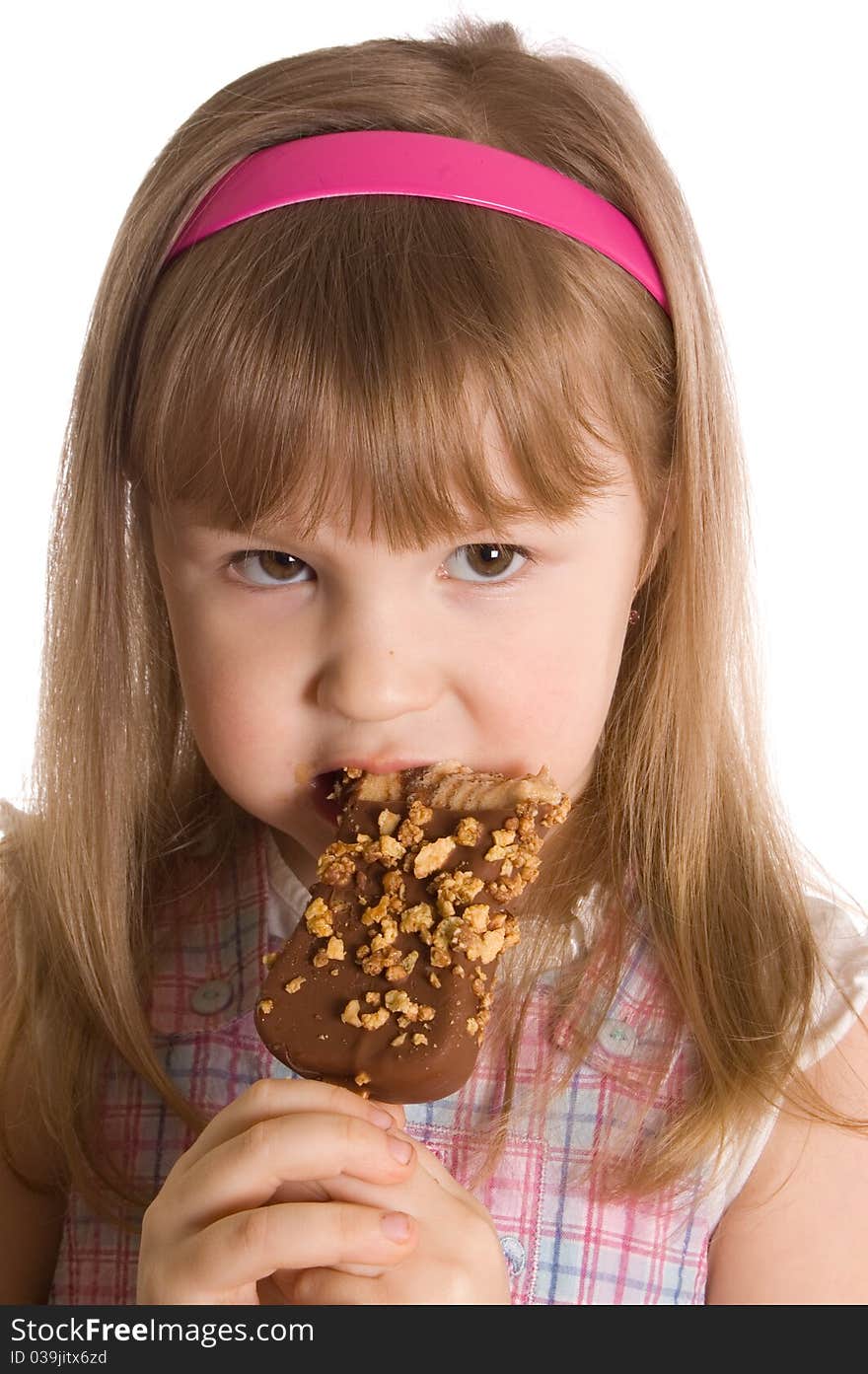 The little girl eats ice-cream on white