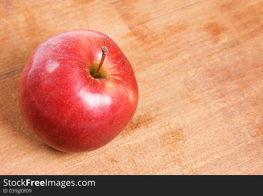 Red apple on a wooden table