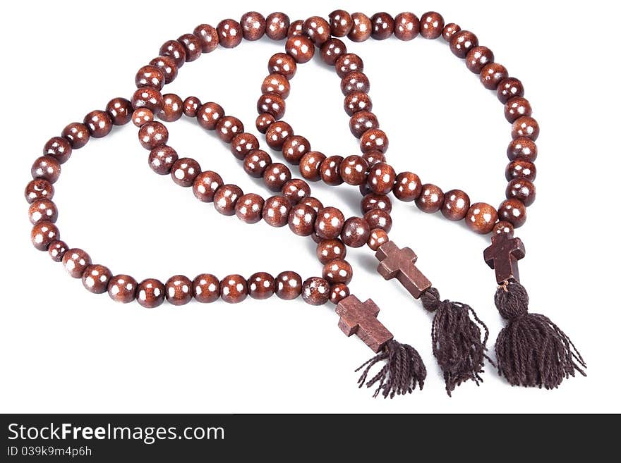 Wooden rosary isolated on white background close up