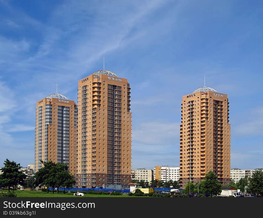 New towerlike buildings against a background of blue sky. New towerlike buildings against a background of blue sky