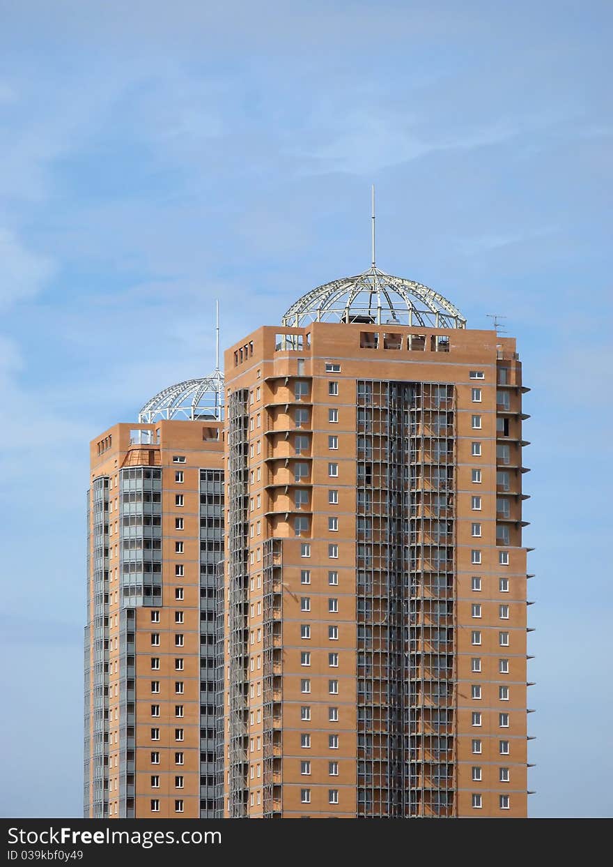 New towerlike buildings against a background of blue sky