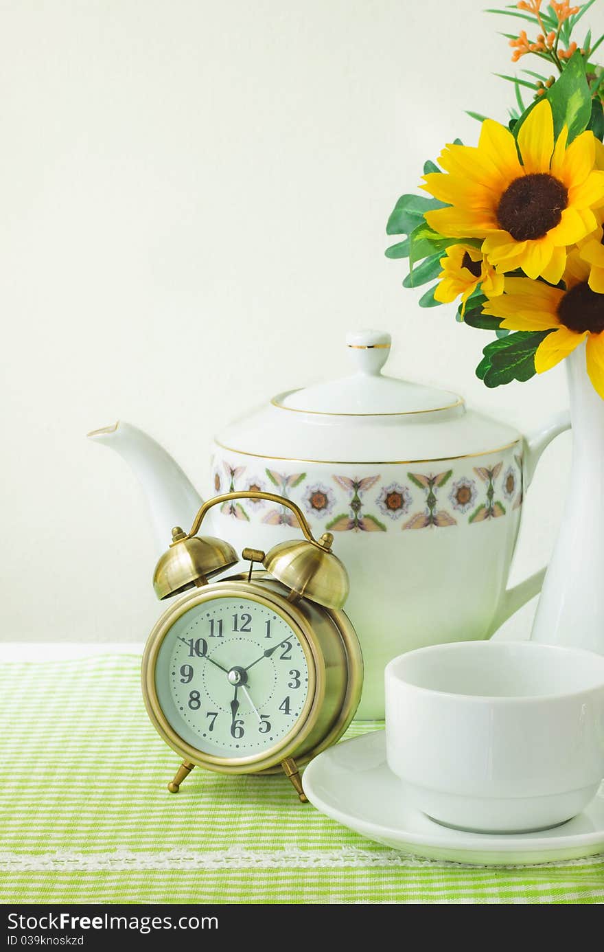 Alarm clock and cup for breakfast background