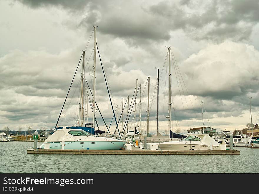 Boats in moorage against clouds