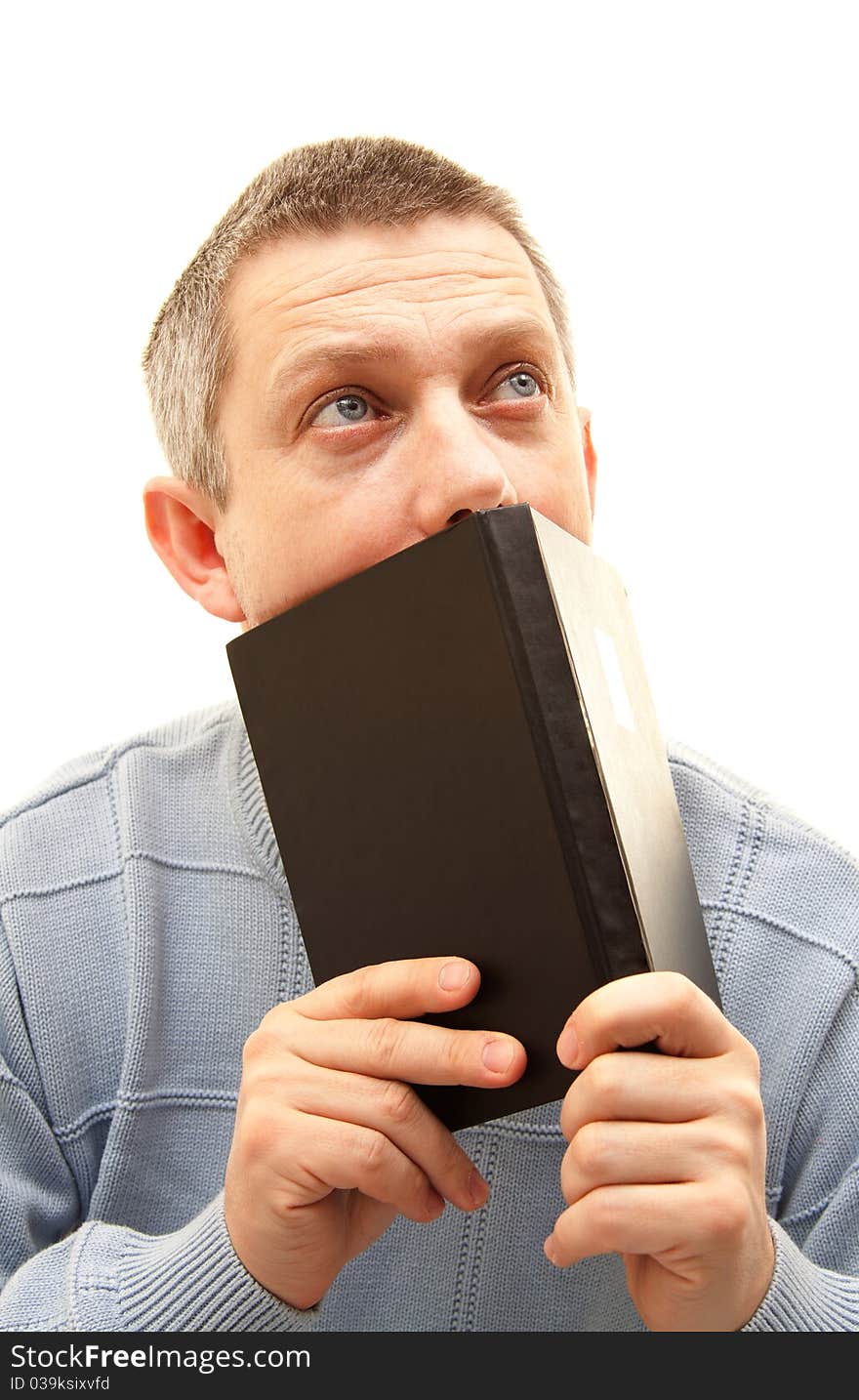 Young man with book looking up