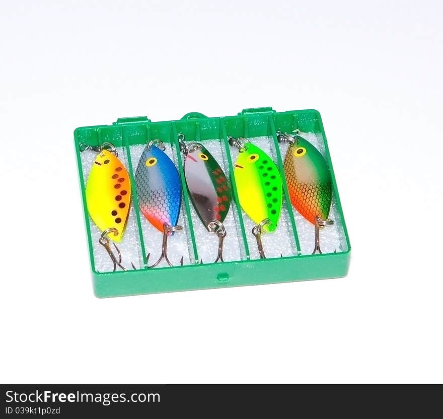 A box of brightly colooured lures isolated against a white background. A box of brightly colooured lures isolated against a white background