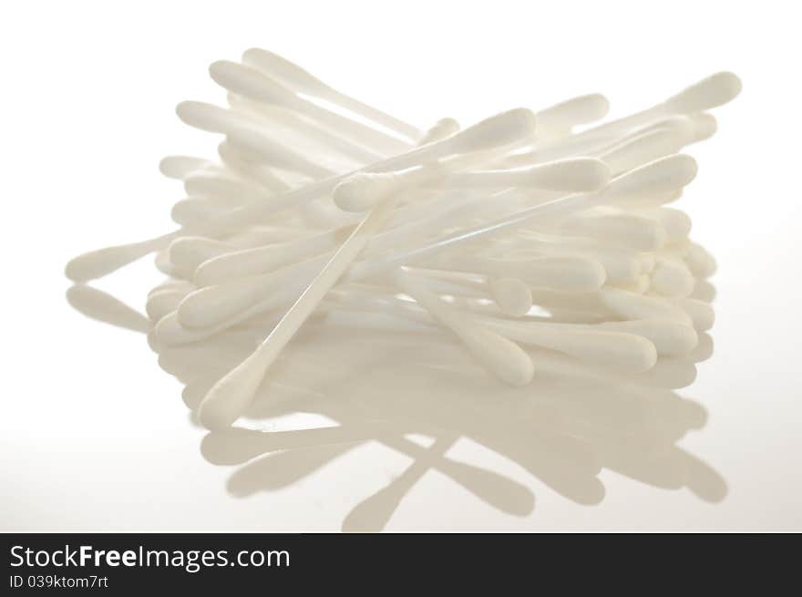 Cottonwool buds shot with reflection against a white background. Cottonwool buds shot with reflection against a white background