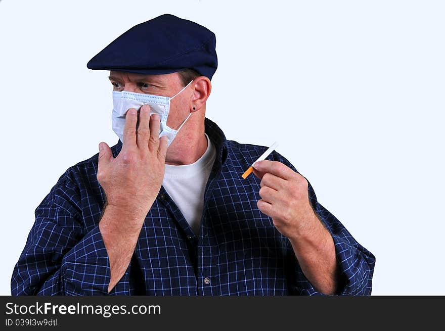 Man with breathing mask on, as if literally turning away from the dangers of a cigarette and the detrimental effects it has on the body. Man with breathing mask on, as if literally turning away from the dangers of a cigarette and the detrimental effects it has on the body.