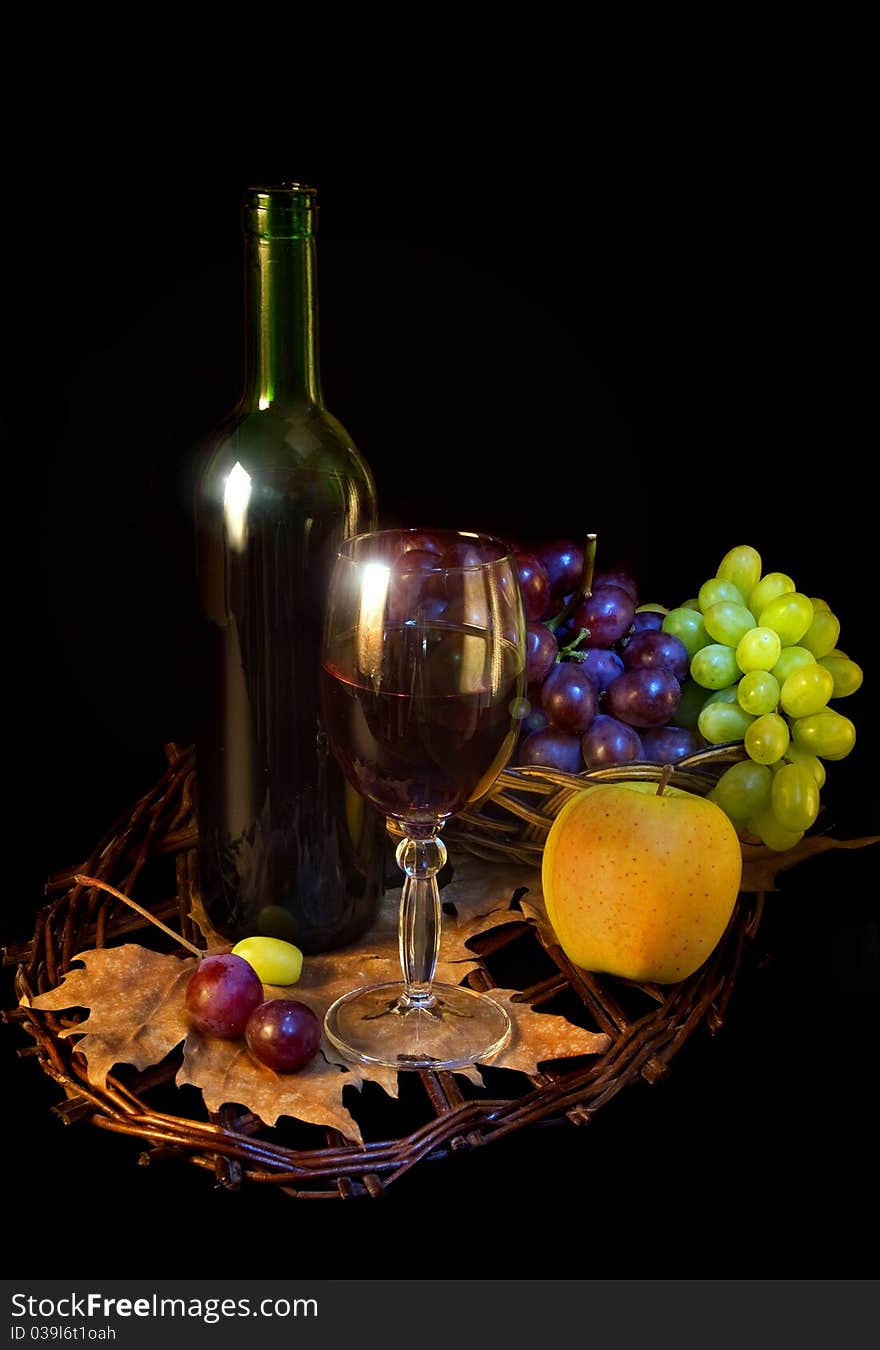 Wine and fruits on black background