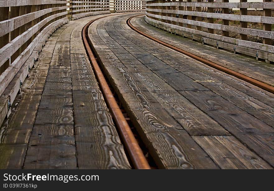 Railroad tracks on a bridge making a curve into the distance; one of a series of railroad images in portfolio. Railroad tracks on a bridge making a curve into the distance; one of a series of railroad images in portfolio