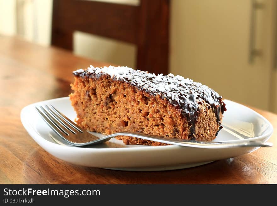 A slice of carrot cake just freshly baked. A slice of carrot cake just freshly baked