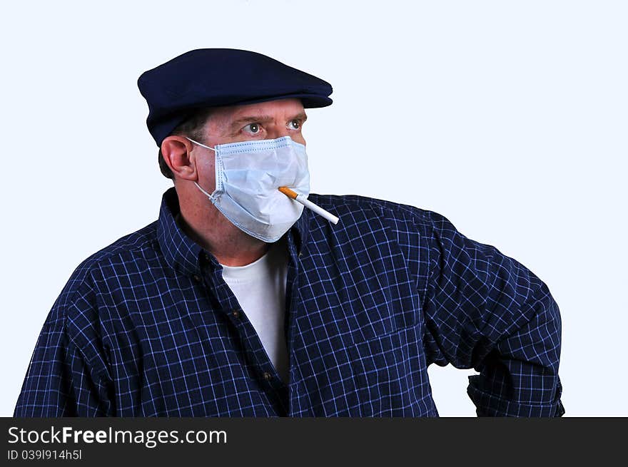 Man holding a cigarette in mouth but with a mask on hoping that would stop the carsinogens from entering his body but still allow him to smoke. Man holding a cigarette in mouth but with a mask on hoping that would stop the carsinogens from entering his body but still allow him to smoke.