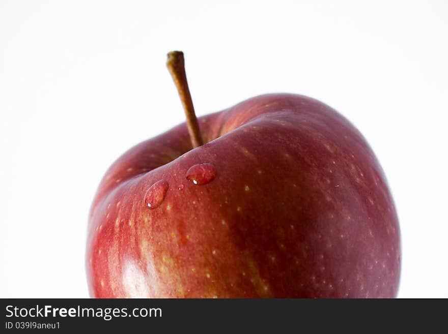 Closeup of droplet in red apple with blur effect. Closeup of droplet in red apple with blur effect