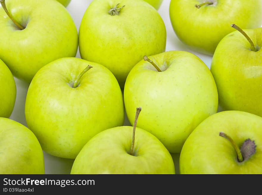 Green and yellow apples on a white background