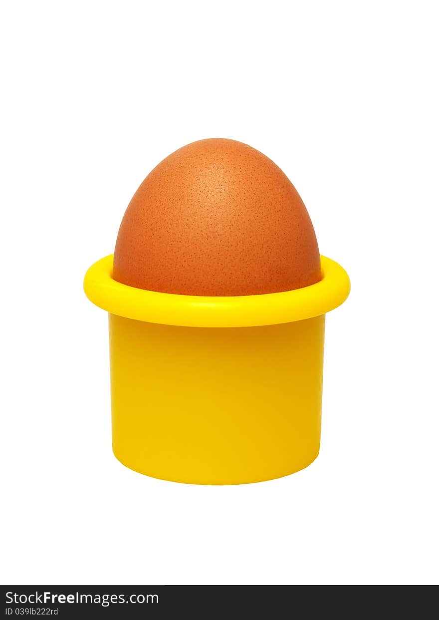 Egg in a yellow eggcup (isolated).