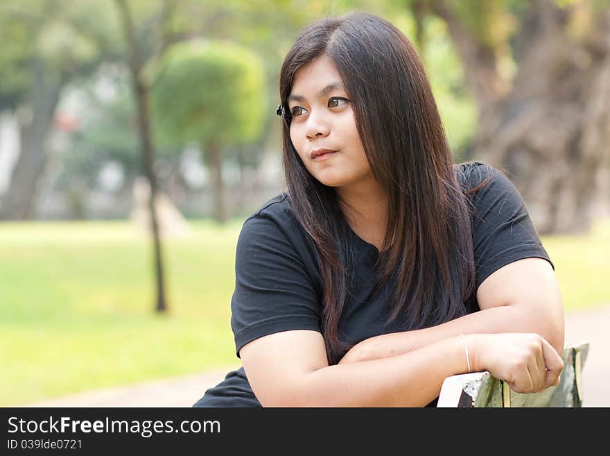 Woman in garden looking absent-minded