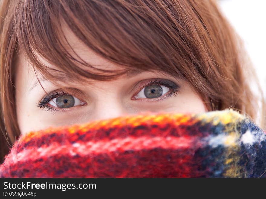 Beautiful young girl who hid herself behind a red scarf. Beautiful young girl who hid herself behind a red scarf