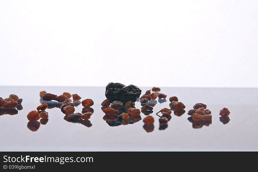 The dried fruit with reflection on a white background