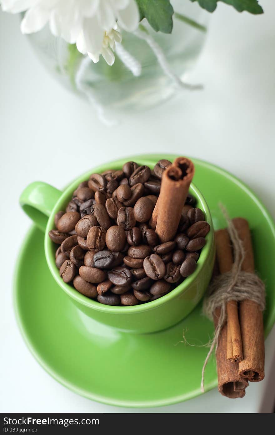 Coffee beans in a green cup